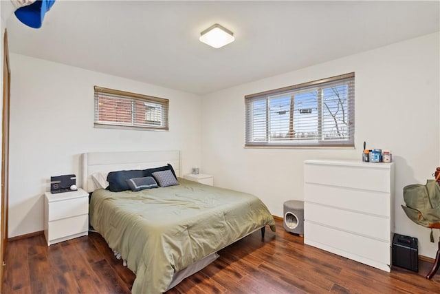 bedroom featuring baseboards and wood finished floors