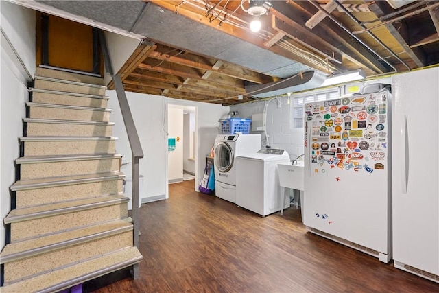 laundry room featuring a sink, laundry area, washer and clothes dryer, and wood finished floors