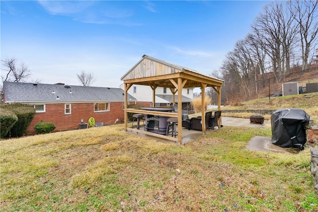 view of yard with cooling unit, a fire pit, a patio, and a gazebo