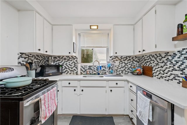 kitchen with white cabinets, light countertops, and a sink