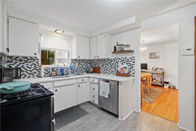 kitchen featuring light countertops, stainless steel dishwasher, a sink, and gas range