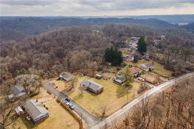 birds eye view of property with a wooded view