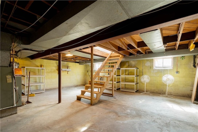 basement with stairs and heating unit