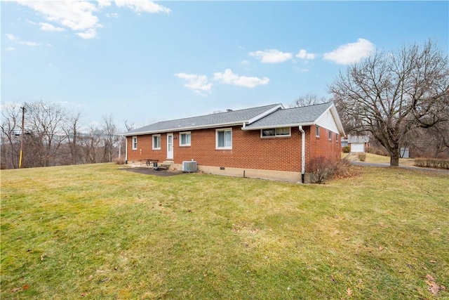 back of house featuring a yard, brick siding, a patio area, and cooling unit