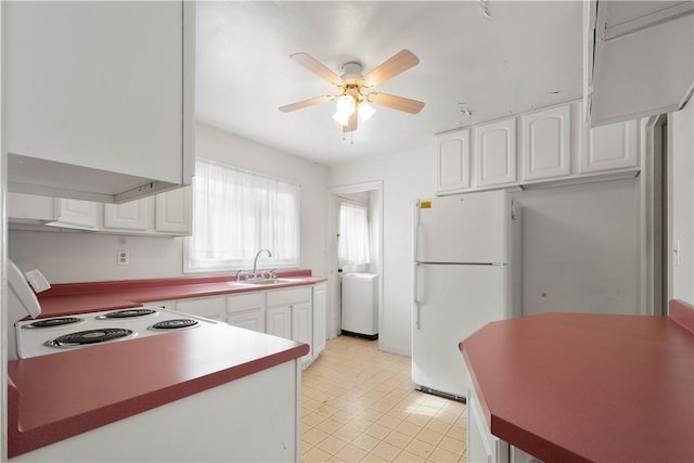 kitchen with white appliances, ceiling fan, white cabinets, and a sink