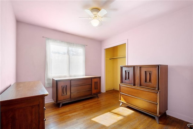 bedroom with light wood-style flooring and baseboards