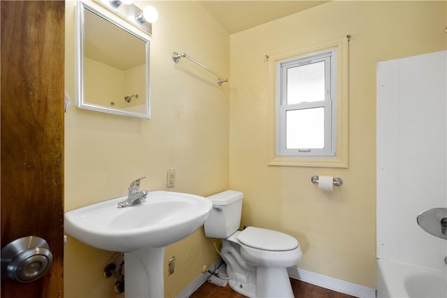 bathroom with toilet and baseboards