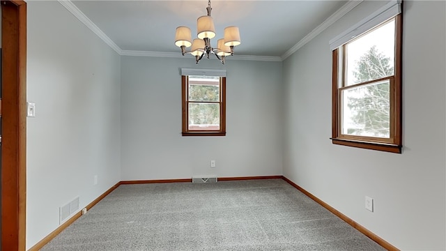 carpeted spare room featuring baseboards, ornamental molding, visible vents, and a notable chandelier