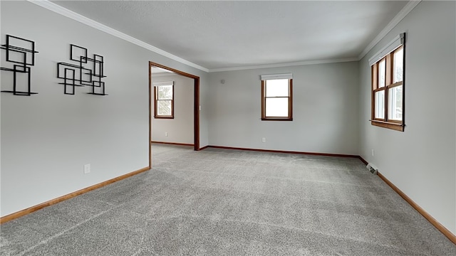 unfurnished room with ornamental molding, light colored carpet, and baseboards