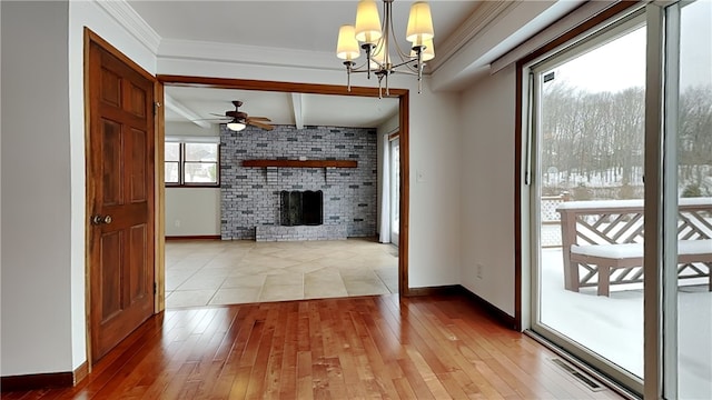 unfurnished living room featuring hardwood / wood-style flooring, baseboards, ornamental molding, a brick fireplace, and beamed ceiling