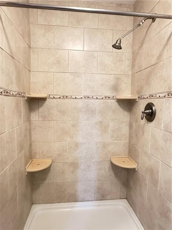 bathroom with a tile shower