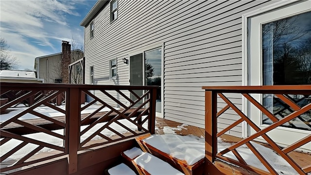 view of snow covered back of property