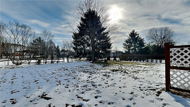 yard covered in snow with fence