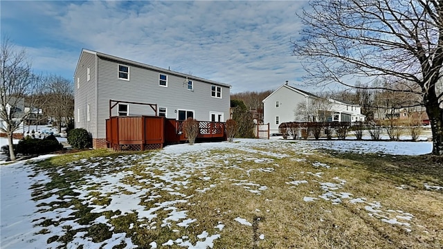 snow covered property with a deck