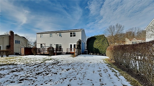 snow covered property with a deck