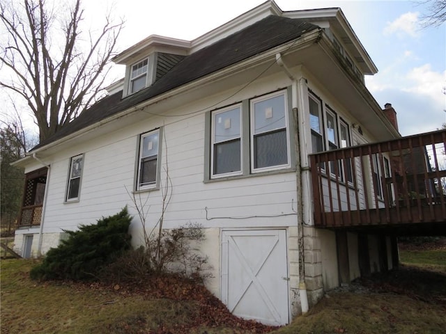 view of side of home featuring a deck