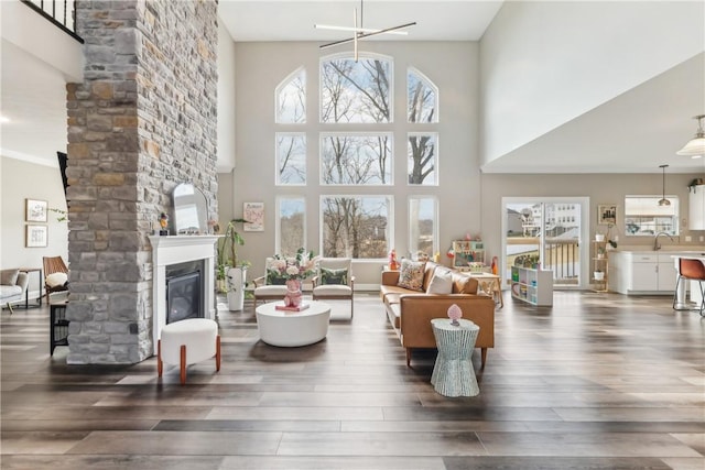 living area featuring a wealth of natural light, a fireplace, and wood finished floors