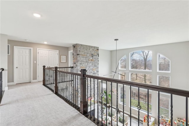 hall with recessed lighting, carpet flooring, an upstairs landing, and baseboards