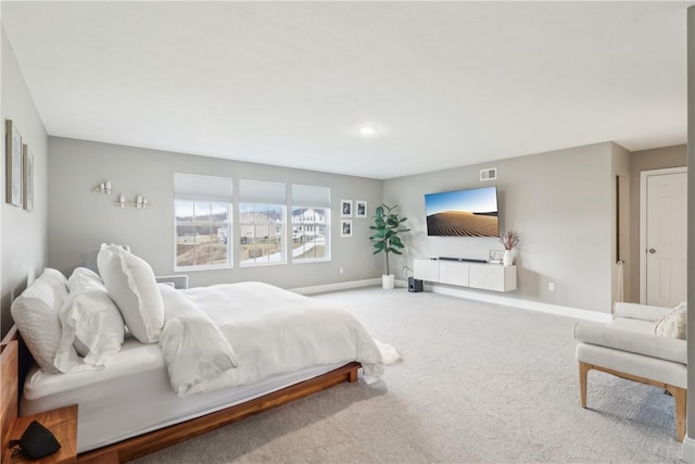 carpeted bedroom with visible vents and baseboards