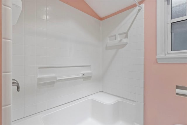 bathroom featuring a shower and lofted ceiling