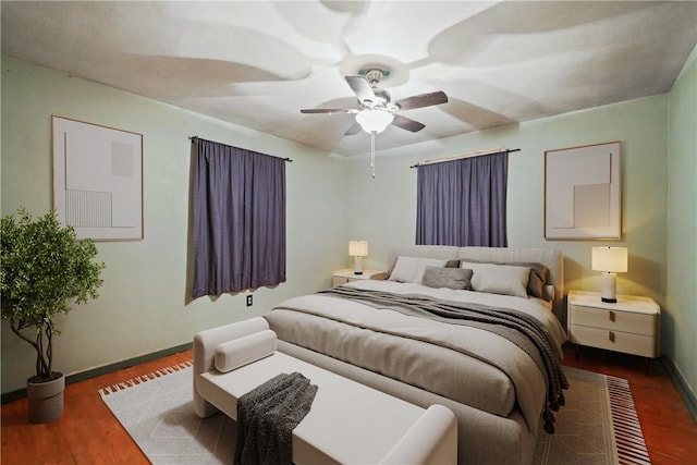 bedroom with baseboards, a ceiling fan, and wood finished floors