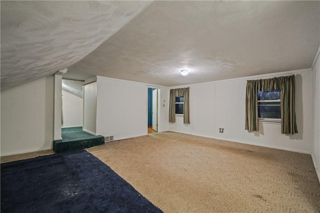 bonus room featuring a textured ceiling and visible vents