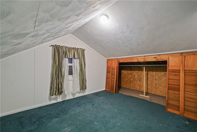 bonus room featuring carpet floors, vaulted ceiling, and a textured ceiling