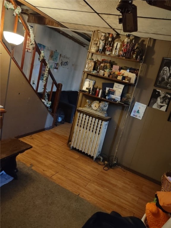 bar with radiator and wood finished floors