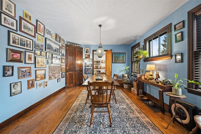 dining space featuring wood finished floors and baseboards