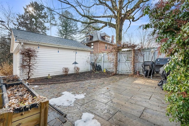 view of patio with an outbuilding and fence