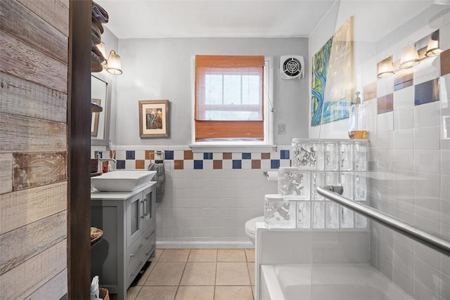 full bath featuring visible vents, tile walls, tile patterned floors, vanity, and a bath