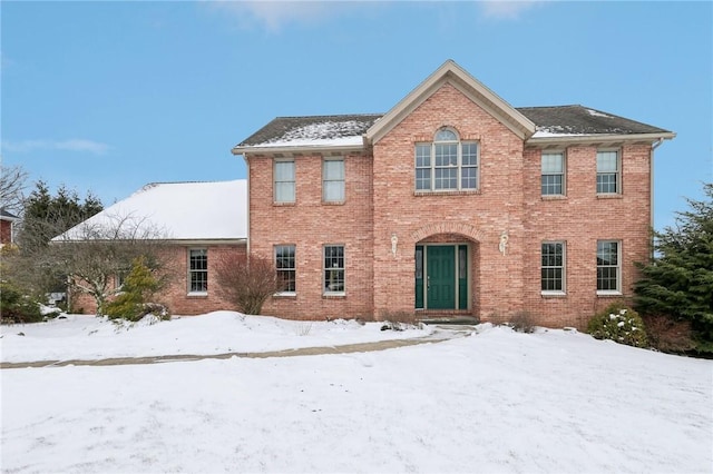 colonial-style house featuring brick siding