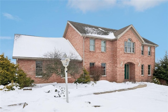 colonial-style house featuring brick siding