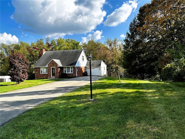 view of front of home with driveway, a garage, a chimney, a front lawn, and brick siding