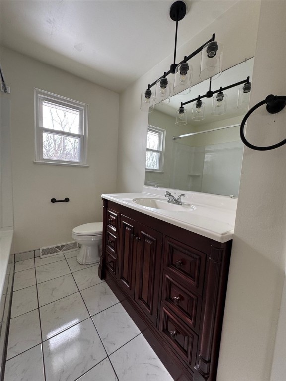 bathroom featuring marble finish floor, visible vents, vanity, and toilet