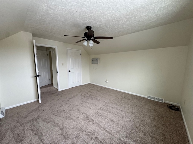 bonus room featuring vaulted ceiling, carpet floors, visible vents, and baseboards