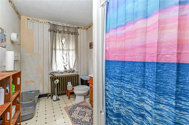 full bathroom with a textured ceiling, radiator heating unit, toilet, and tile patterned floors