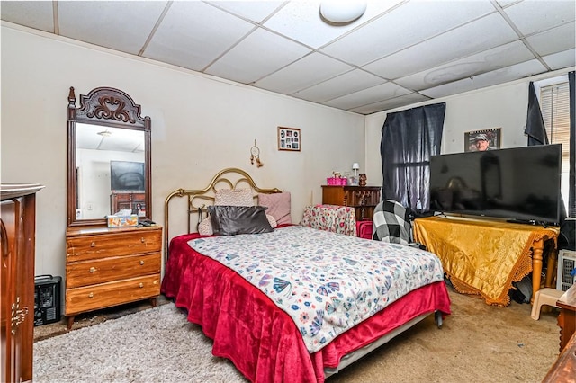 bedroom with carpet and a paneled ceiling