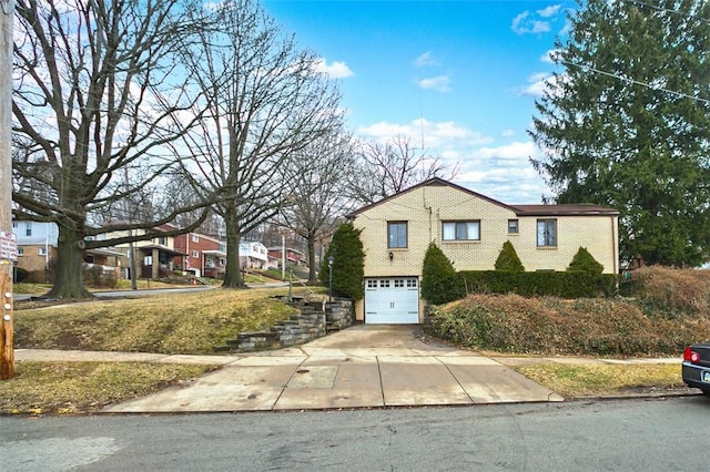 view of front of house featuring concrete driveway, brick siding, and an attached garage