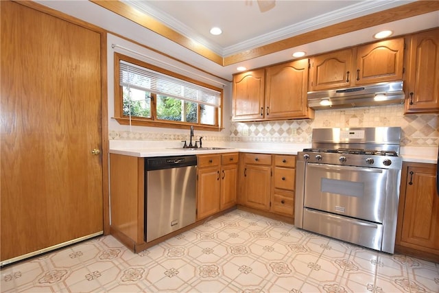 kitchen featuring ornamental molding, stainless steel appliances, light countertops, under cabinet range hood, and a sink