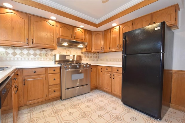 kitchen featuring brown cabinets, light countertops, ornamental molding, under cabinet range hood, and black appliances