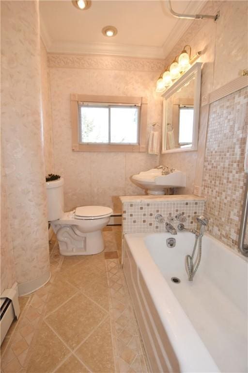 full bath featuring crown molding, a baseboard radiator, baseboard heating, toilet, and a bath