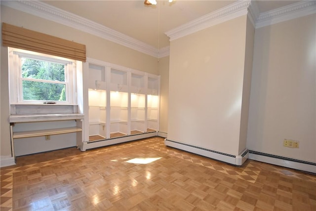 empty room featuring ornamental molding and a baseboard heating unit