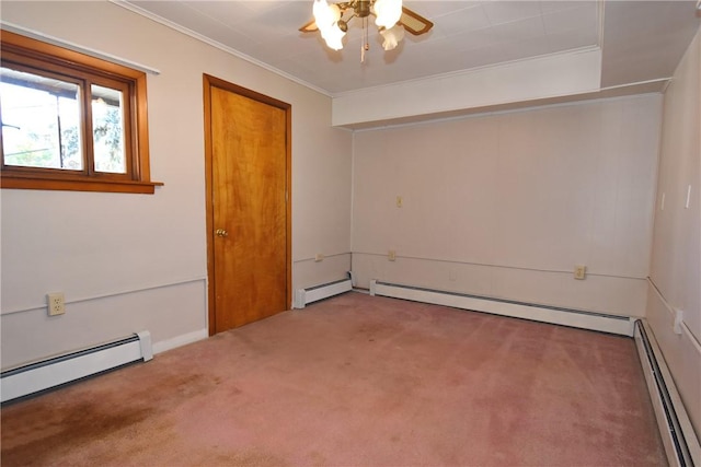 carpeted empty room with a baseboard heating unit and crown molding