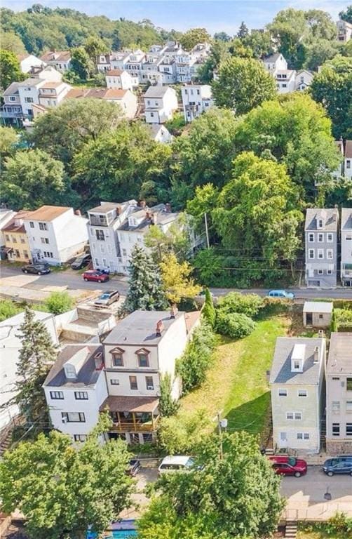 aerial perspective of suburban area featuring a tree filled landscape