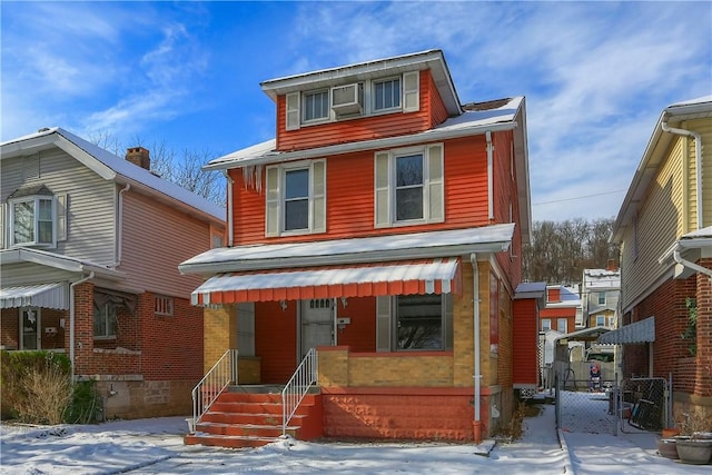 american foursquare style home with covered porch