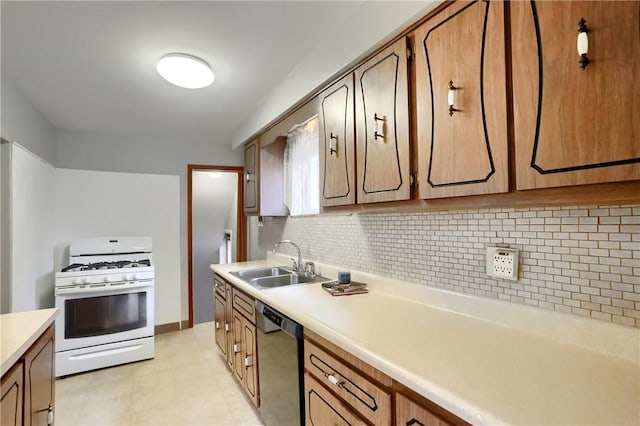 kitchen with white gas stove, a sink, backsplash, light countertops, and dishwasher