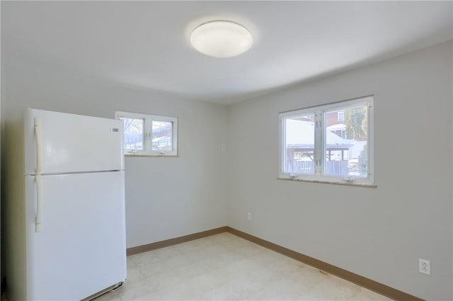 spare room with light floors and baseboards