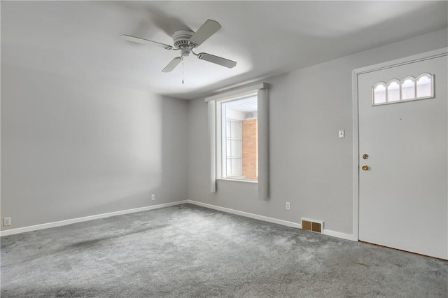 foyer with ceiling fan, carpet, visible vents, and baseboards