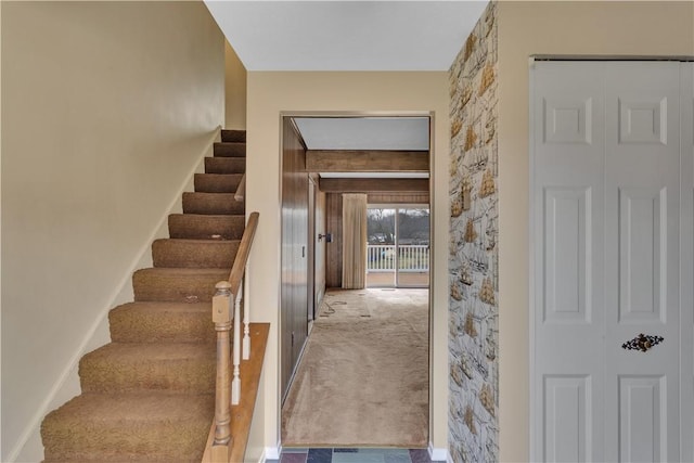 stairway with carpet floors and baseboards